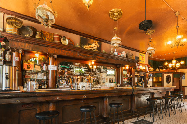 Interior of Shotwell's Bar showing the vintage wooden counter and light fixtures